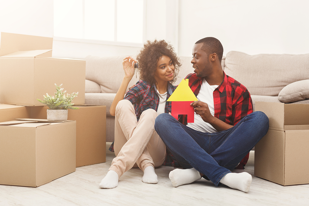 couple-sitting-on-floor-at-new-apartment
